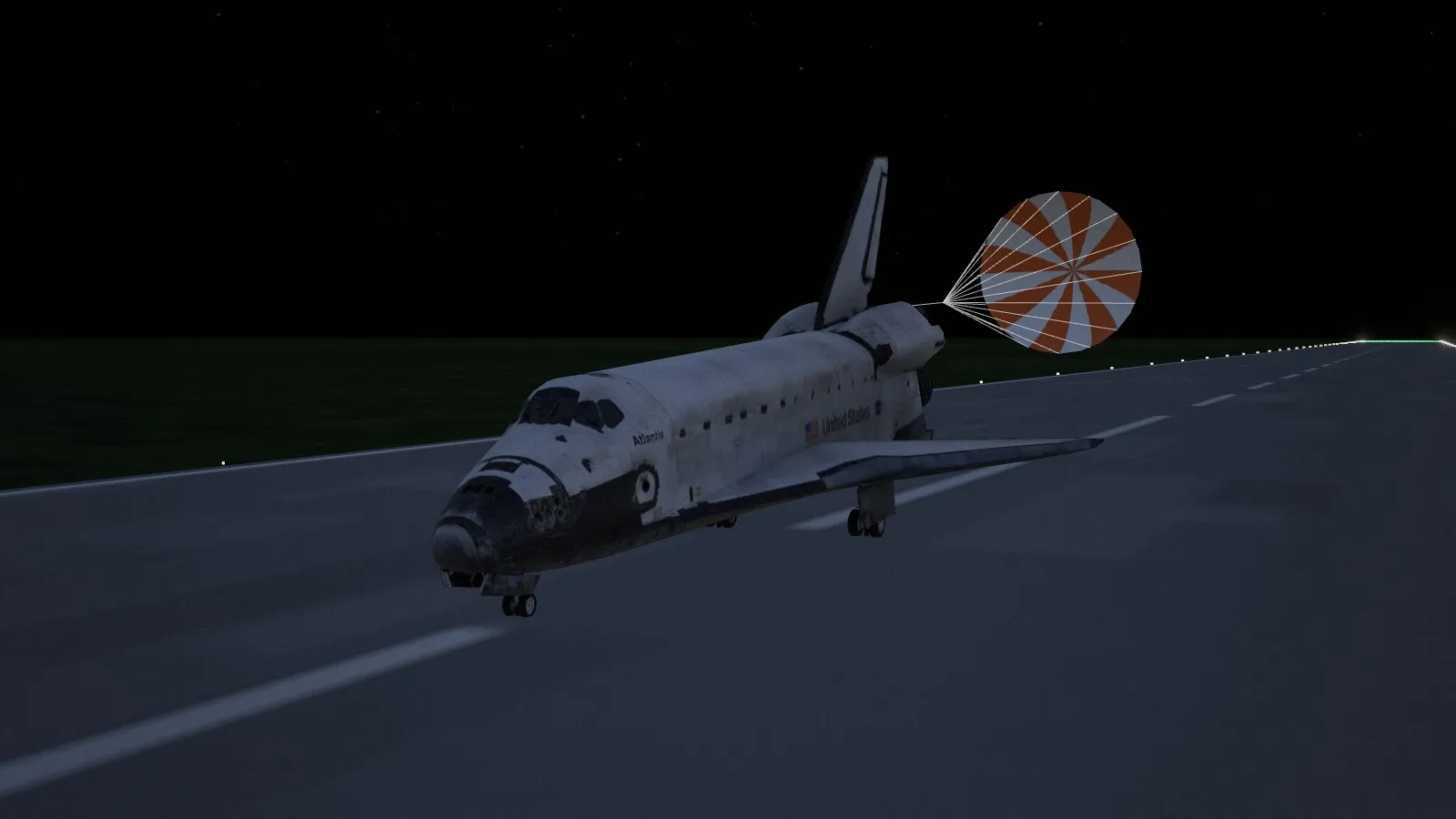 STS-135 rolling out on Runway 15 at Kennedy before dawn, its drag chute out behind it and the runway edge lights on